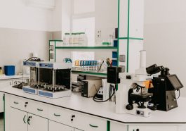 A laboratory countertop featuring various scientific instruments, including a microscope and analytical equipment, in a