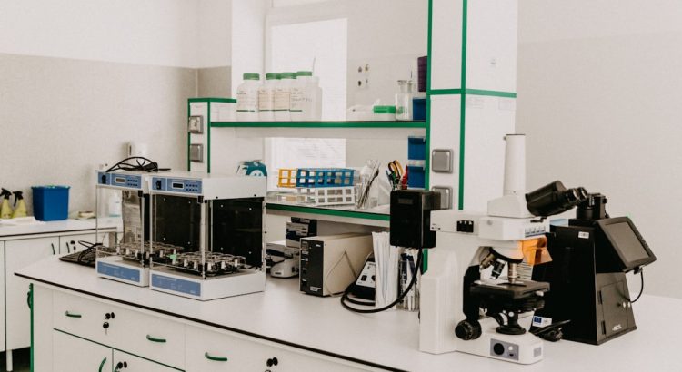A laboratory countertop featuring various scientific instruments, including a microscope and analytical equipment, in a